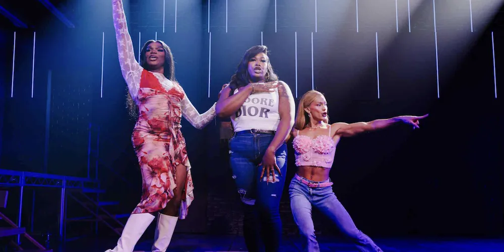 Three performers on stage