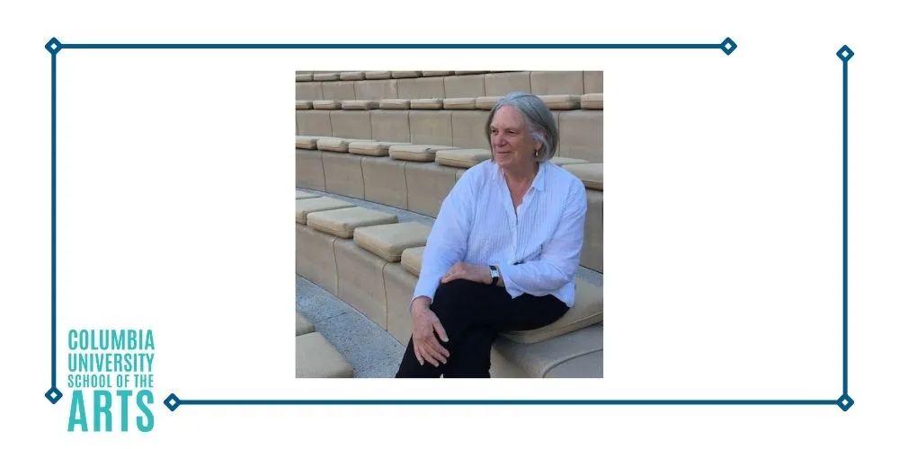 A woman sitting in an outdoor theatre