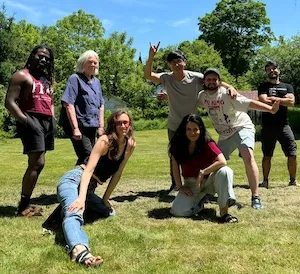 A group of people pose in a field