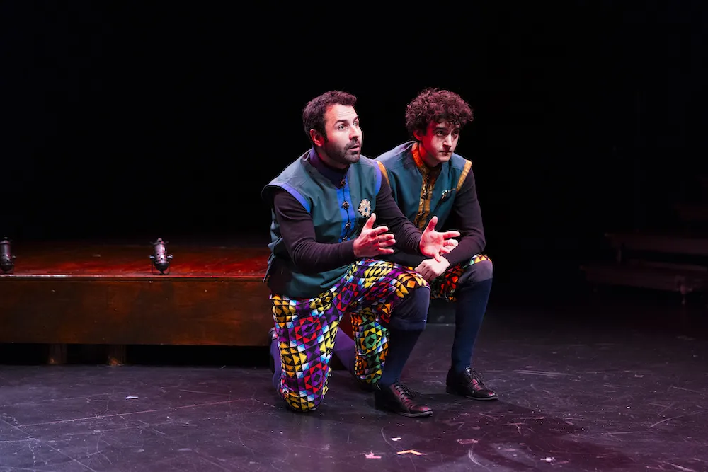 two actors perform on stage
