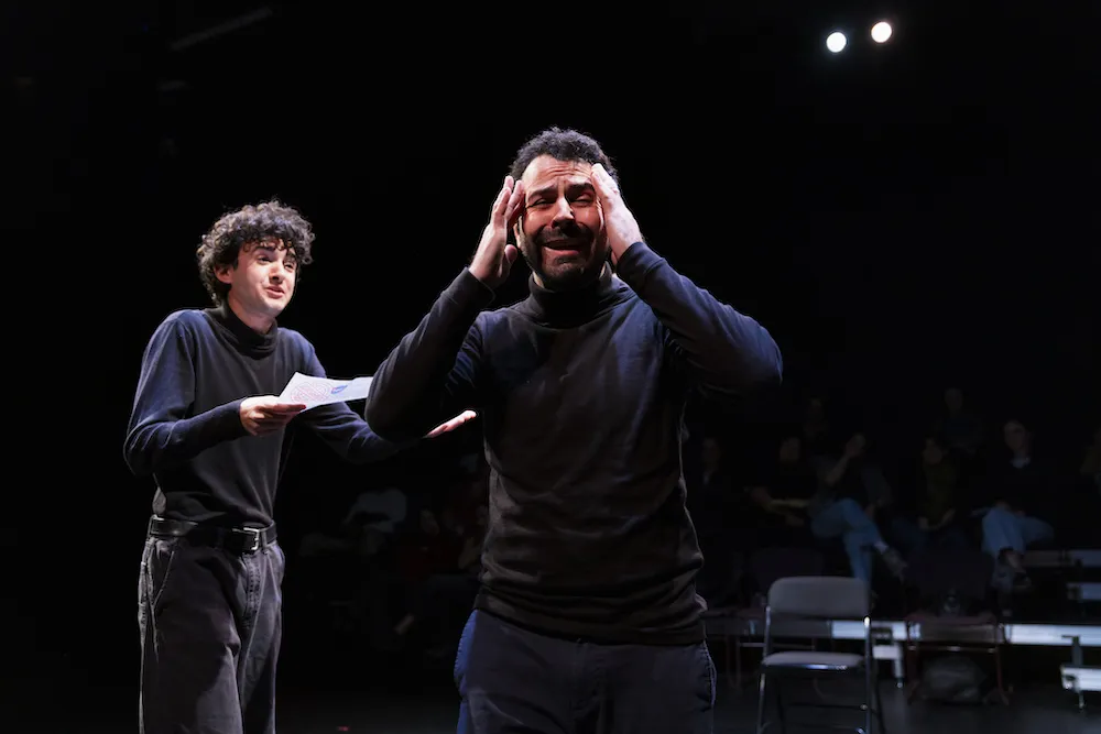 two actors perform on stage
