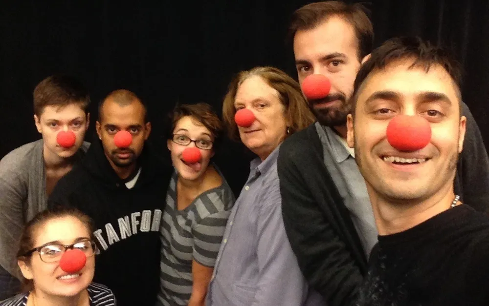 a group of people wearing red clown noses