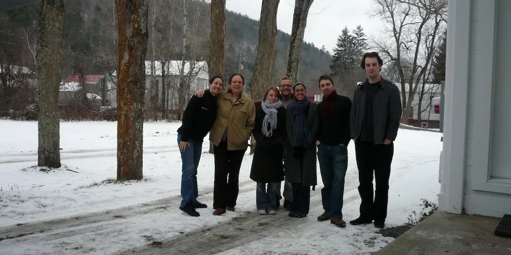 A group of people stand outside 