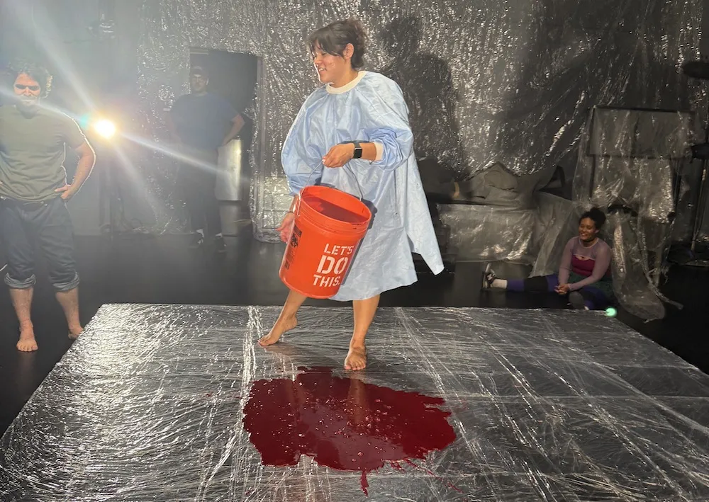 A group of people work on stage for a theater production