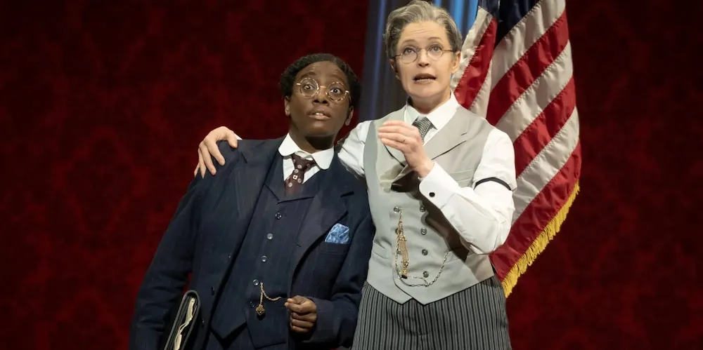 Two women actors dressed as Dudley Malone and President Woodrow Wilson.
