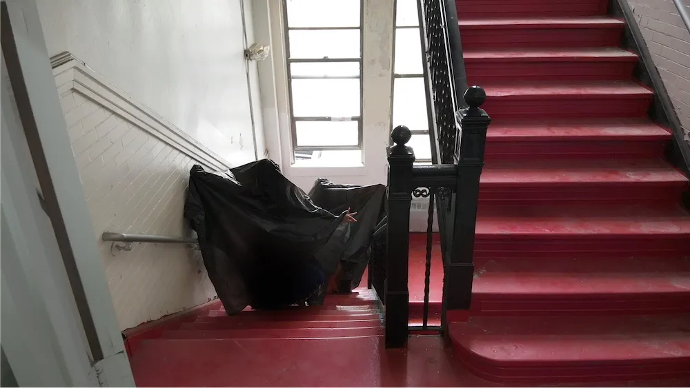 Shrouded dancers in a stairwell