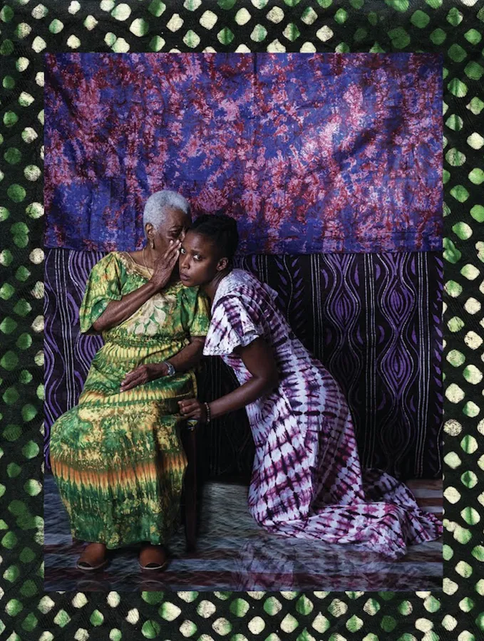 artistic photograph - older woman whispering into ear of younger woman