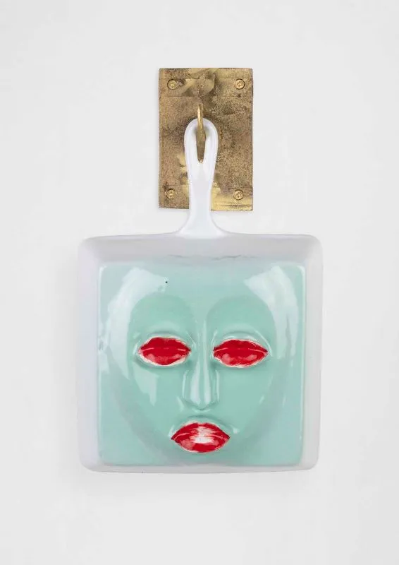 Cookware sculpture with a face