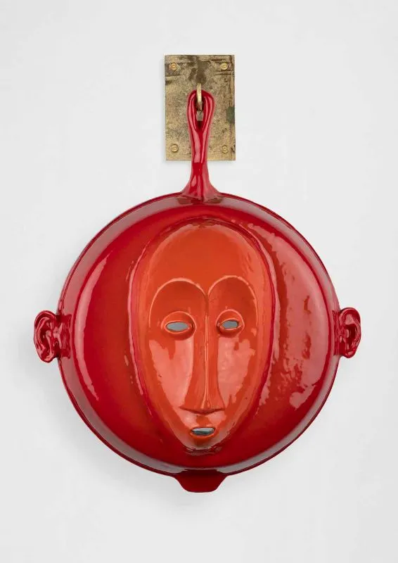 Cookware sculpture with a face