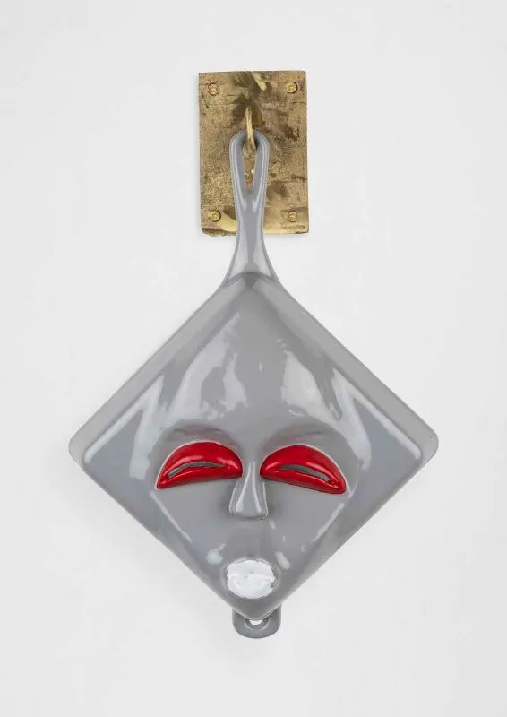 Cookware sculpture with a face