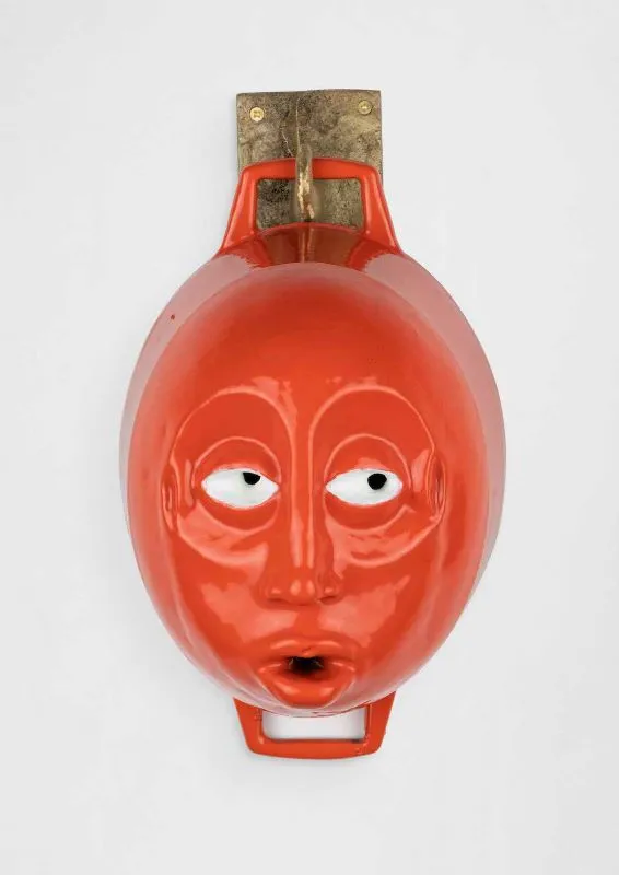 Cookware sculpture with a face