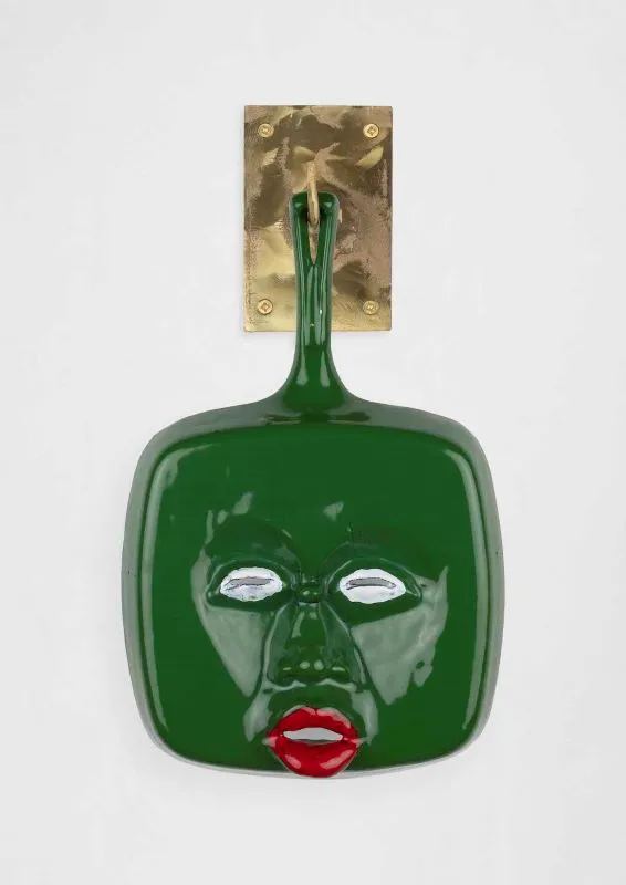 Cookware sculpture with a face