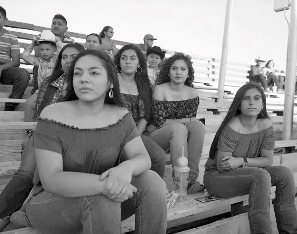 group of young women seated on bleachers