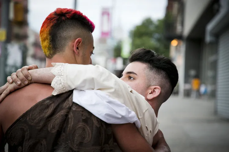 Two people, one holding the other