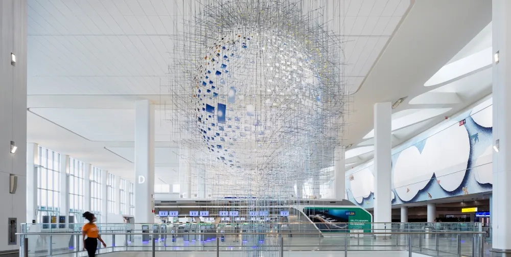 A floating sculpture made up of many hanging photos.