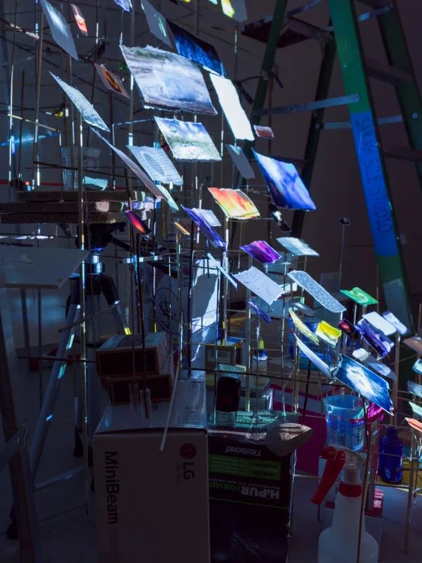 Installation of articulated prints illuminated by blue lights