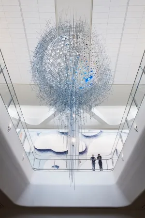A floating sculpture made up of many hanging photos.