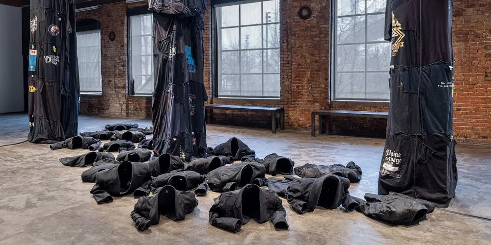 Photo of the installation, empty blazers look like they are moving.