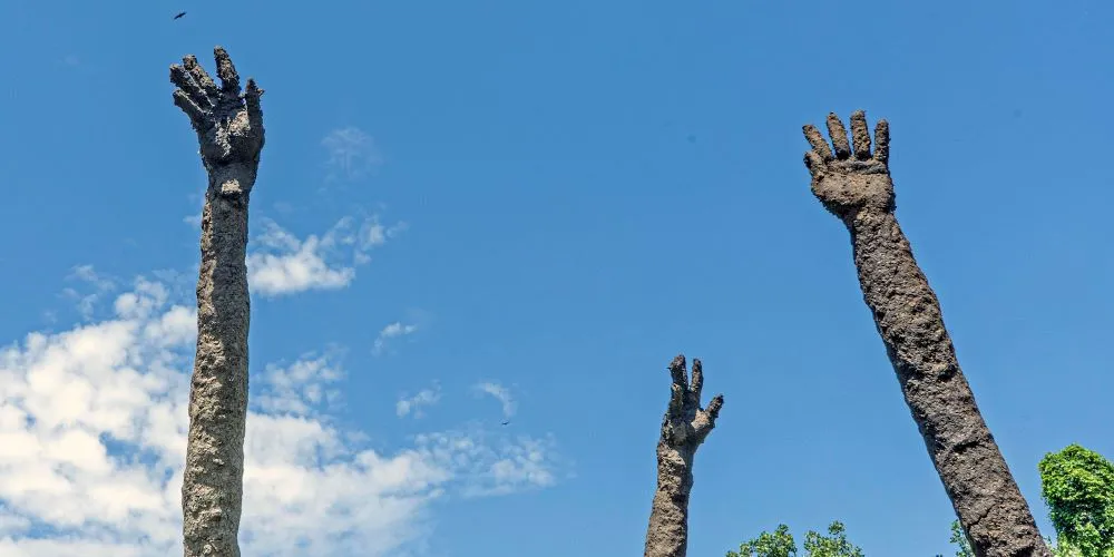Three outside sculptures of elongated arms