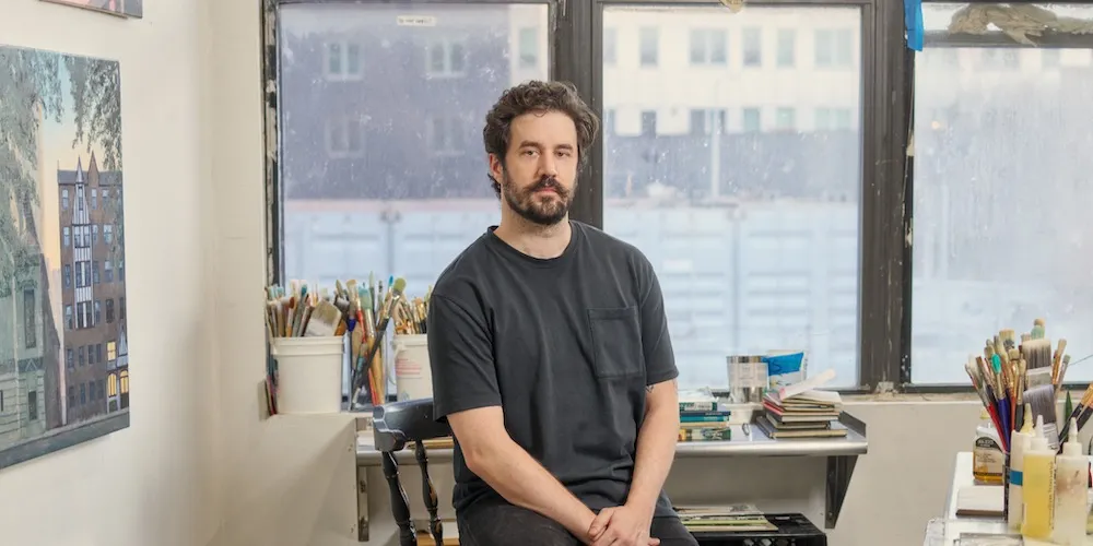 Conor Dowdle sits in his studio. 