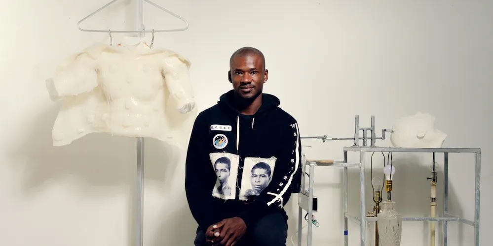 Jeffrey Meris stands next to artwork 