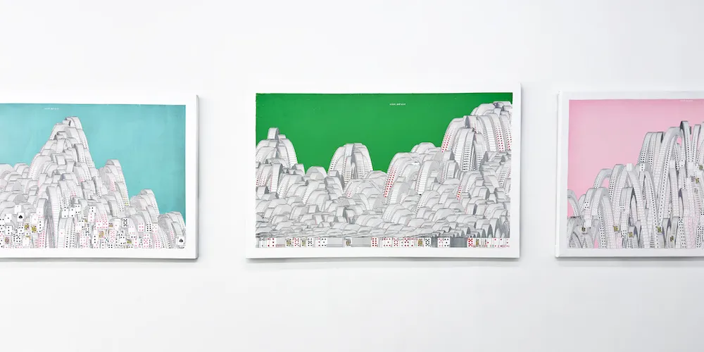 three pieces of artwork on display on a gallery wall