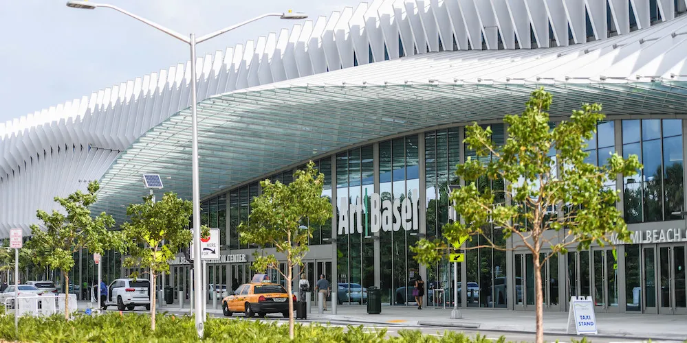exterior of a convention center on a tree-lined street