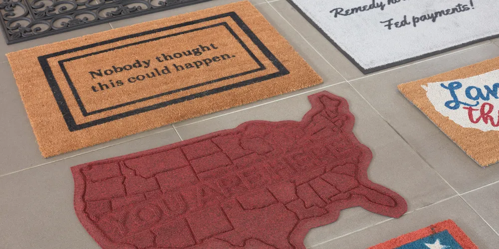 Sophie Kovel, Welcome (Nobody thought this could happen), Welcome (You are here), and Welcome (Remedy now or no more Fed payments!), 2018–2021, coir, flocked coir, carpeted-rubber backed, and waterhog doormats, 24 × 36 × 1 inches and 18 × 30 × 1 inches each.