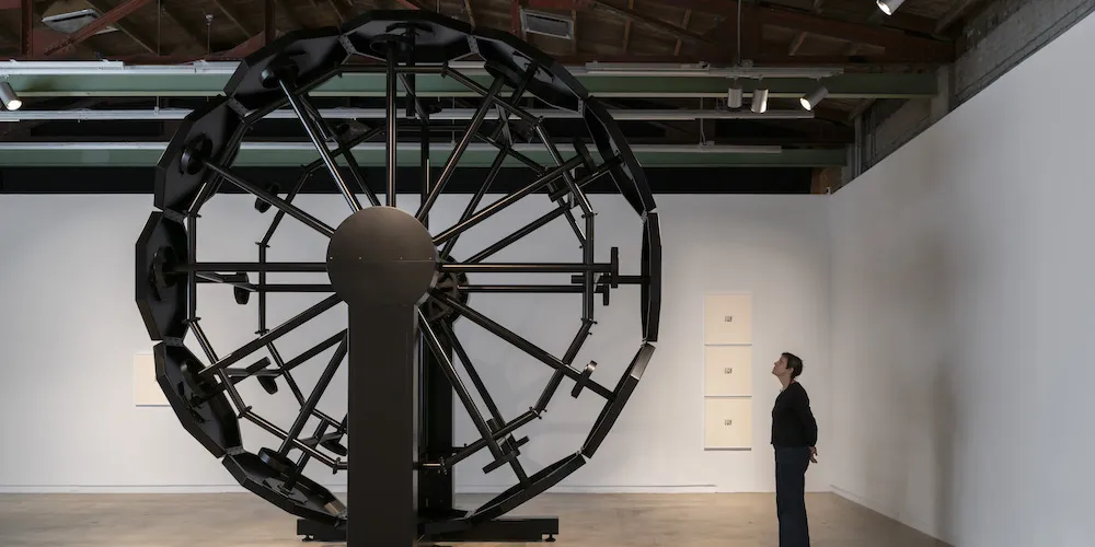 a person looks at artwork in a gallery