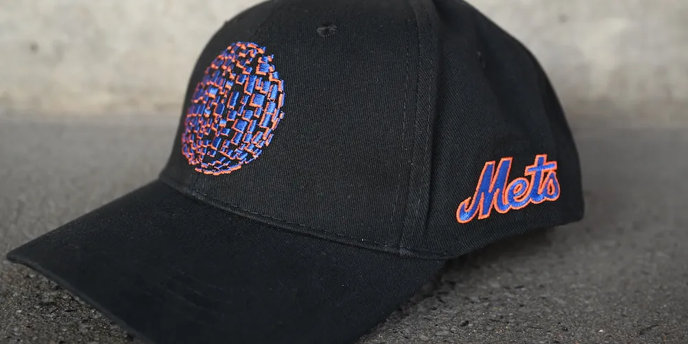 Black baseball cap with blue and orange sphere and NY Mets logo.
