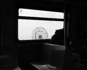 Black and white photograph of a ferris wheel. 