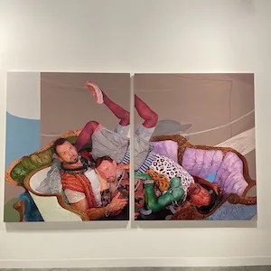 a painting split between two canvasses on display in a gallery