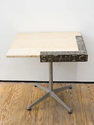table on wheels with steel sculptural piece attached