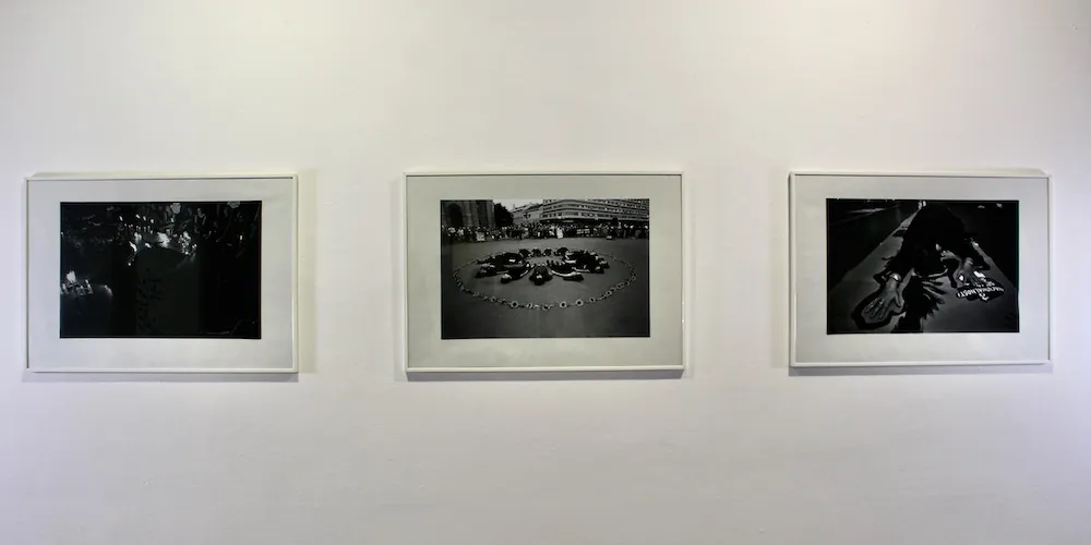 three framed photographs on display in an art gallery