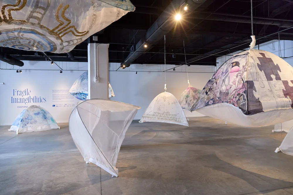 silk organza camping tents arranged in various stages of suspension in an art gallery