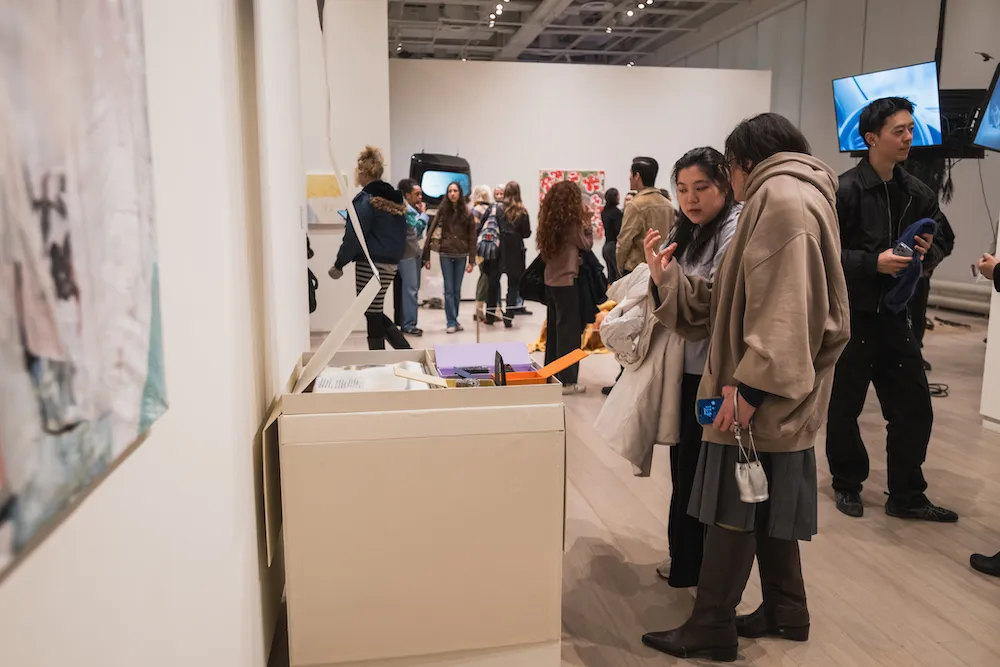 people look at artwork in a gallery