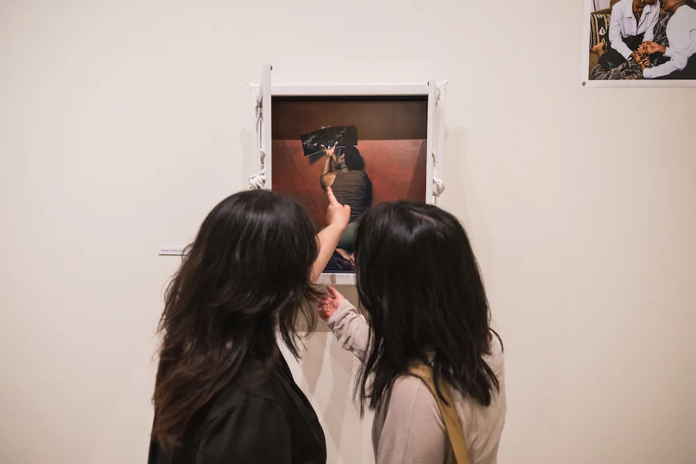 two people interact with a piece of art in a a gallery