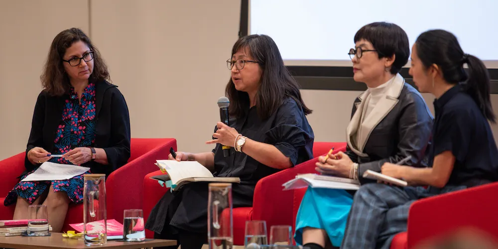 Four women engaged in discussion onstage