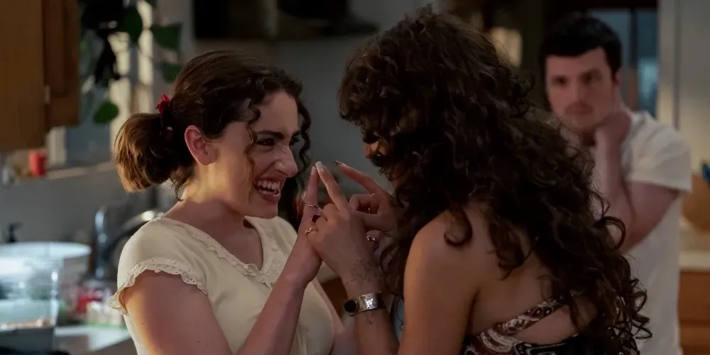 two girls talk to each other closely
