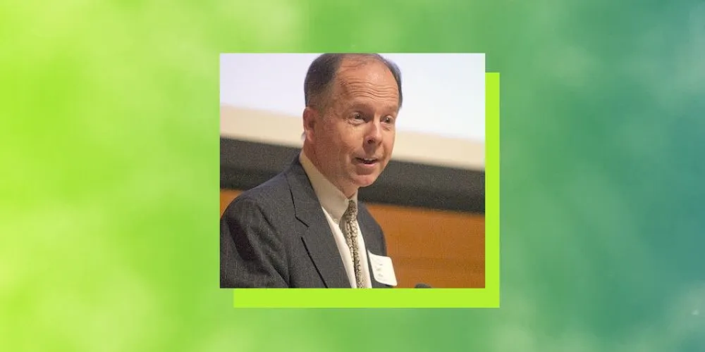 Headshot of Carl Little on a green background