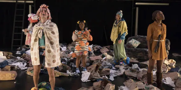 Students on stage in clown costumes