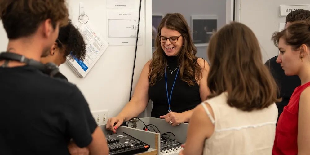 an instructor shows students how to use a tech board