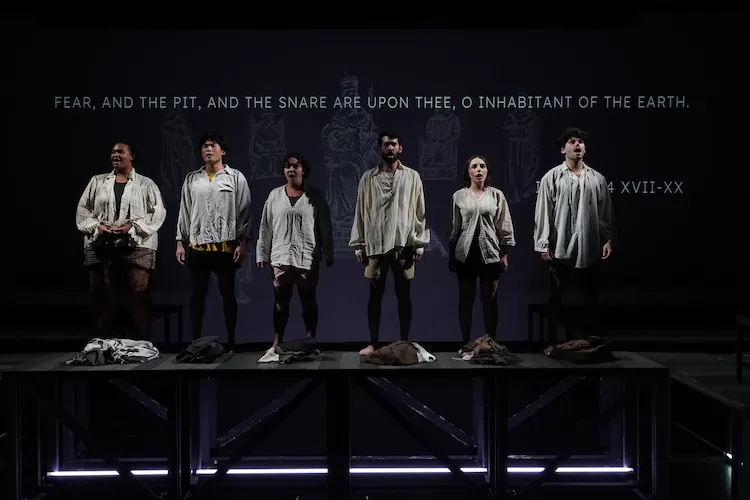 Six actors perform on stage.