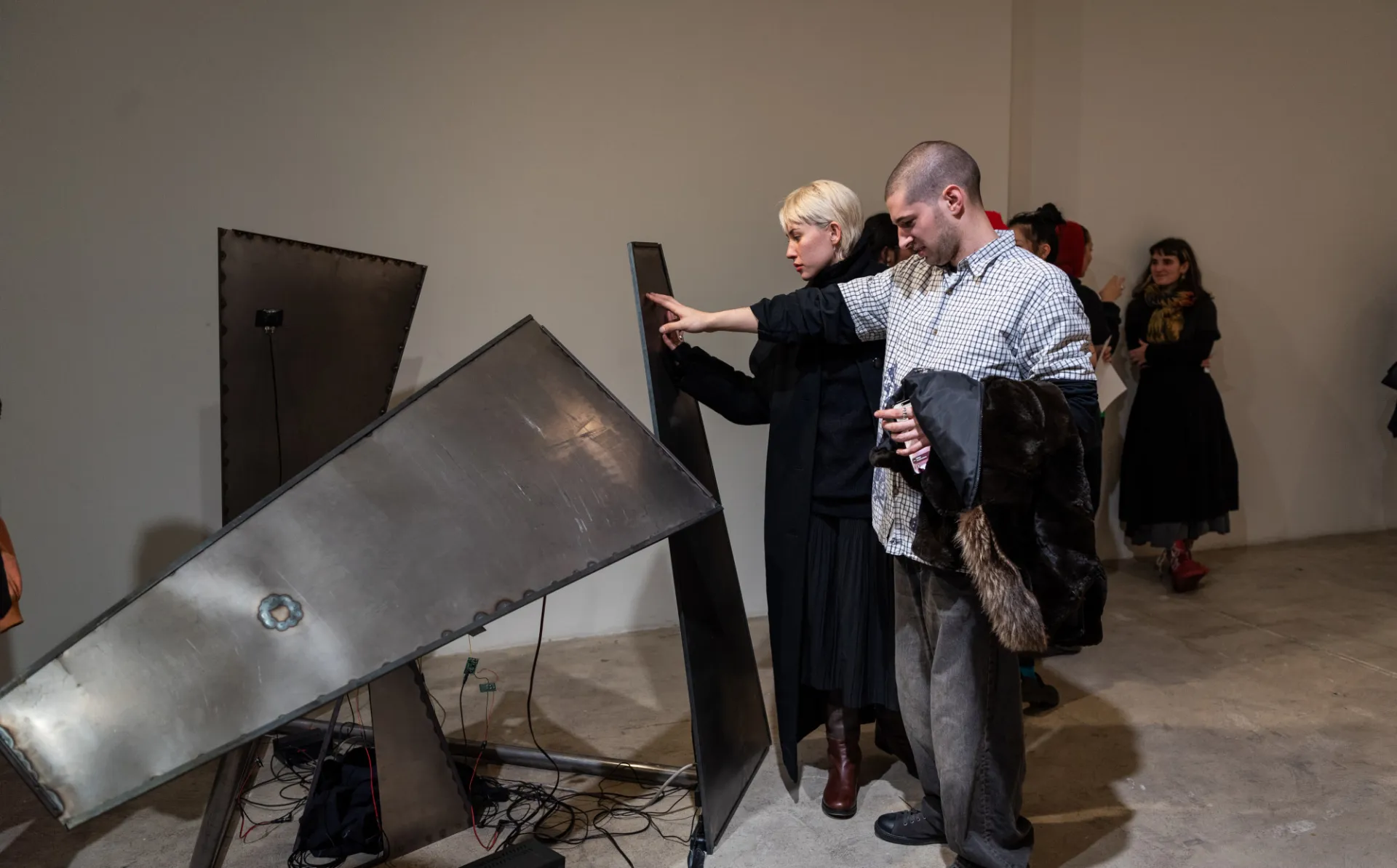 two people interact with a sound art installation