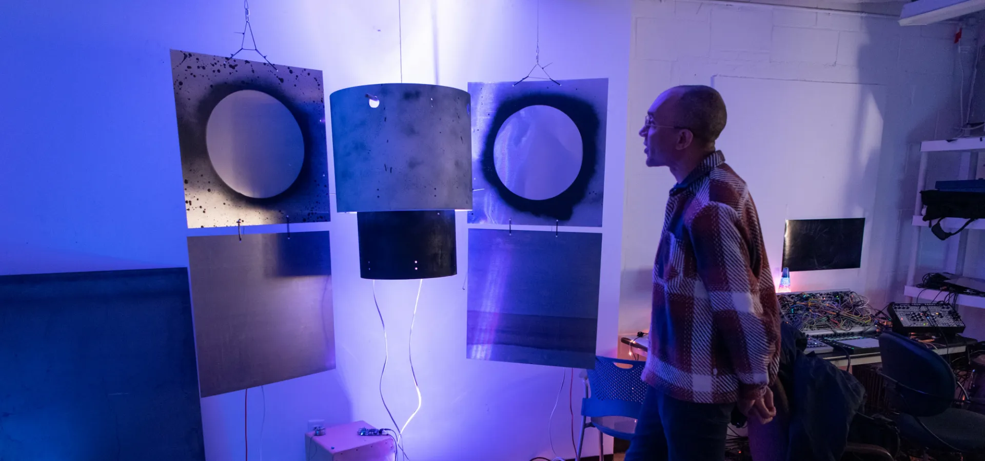 a person observes a sound art installation