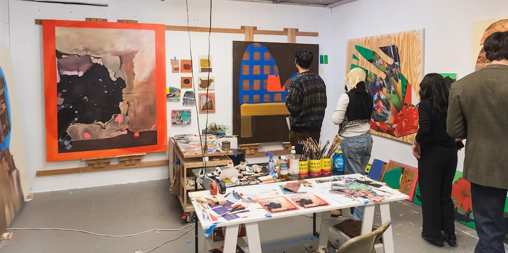 people look at art in a studio space