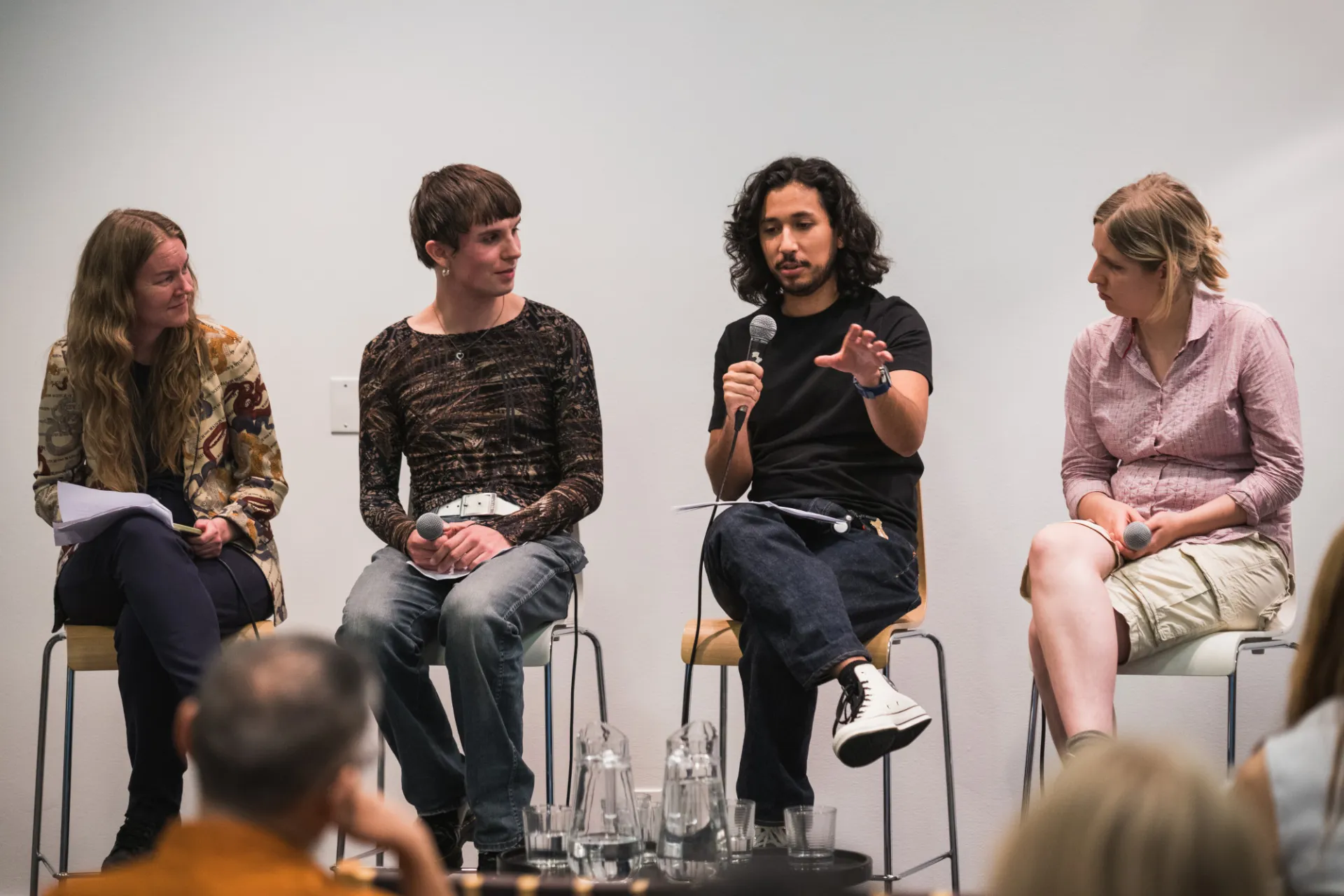 a group of people speak on stage