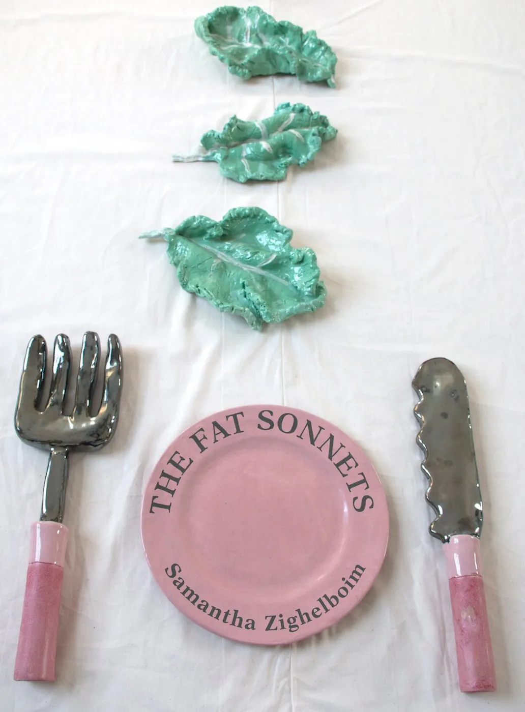 Cover of 'The Fat Sonnets' - an empty pink plate with pink fork on the left and pink knife on the right. Three leaves are laid out in front of the plate in a straight line.