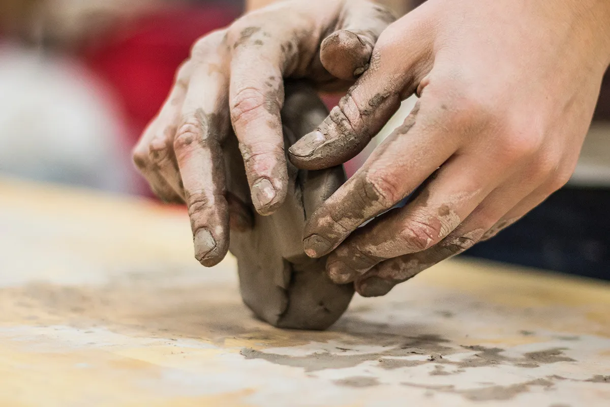 Hands molding clay