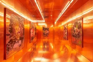 a bright orange space with lights and art